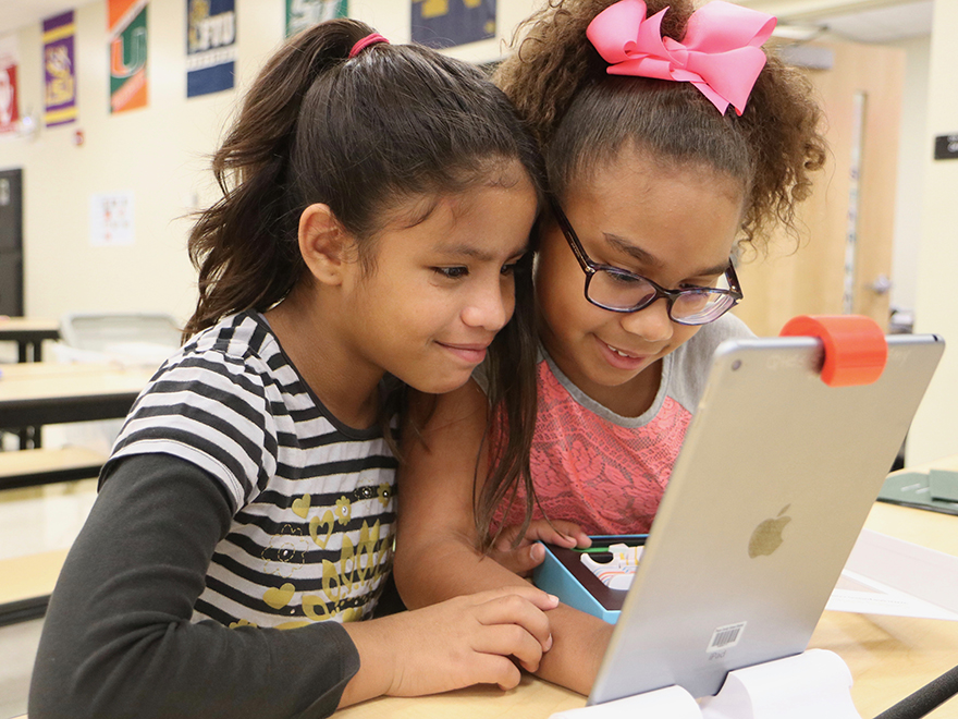 two students on ipad - 
